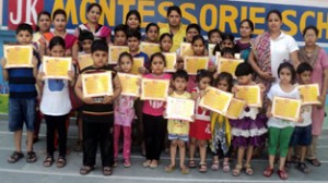 Children displaying certificates during the concluding ceremony of Summer Camp at Montessorie School in Jammu.