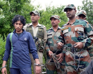 Army and police produce an arrested Pakistani militant, Mohammad Qasim before media persons. Another pic on page 6. —Excelsior/Sajad Dar