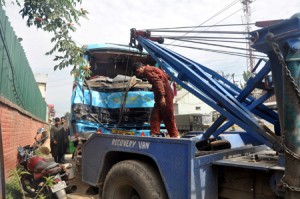 A damaged Tata 407 passenger vehicle being lifted by a crane after vehicle skidded off the road and rolled down into a deep gorge at Sangam on Wednesday.  -Excelsior/Sajjad Dar