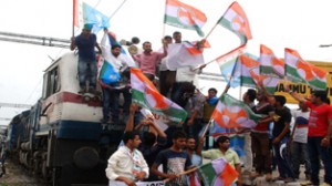 Youth Congress and NSUI activists halted train to lodge their protest against hike in rail fare at Jammu on Wednesday.-Excelsior/Rakesh