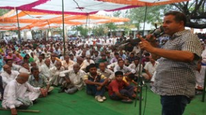 JSM MLA Ashwani Sharma addressing a rally at Rahal, Bishnah on Sunday. 