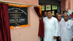 Minister for PHE, Sham Lal Sharma laying foundation stone of check dam at Akhnoor on Sunday.