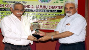 Memento being presented and received by the dignitaries during National Symposium in Jammu.