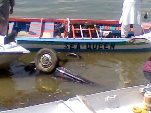 Tyres of Santro car are seen in Dal lake.