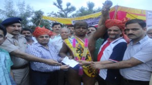 Wrestlers being felicitated by the dignitaries in Reasi on Sunday.