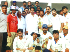 Jubilant RCC Srinagar team posing for a group photograph alongwith Minister for Sports, Raman Bhalla after lifting the T20 title in Jammu on Sunday.