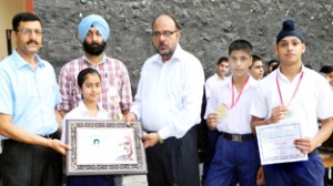 Ayushi holding citation of Sher-i-Kashmir Sports Award and other meritorious sports persons of BSF School Paloura being felicitated in the School premises on Thursday.