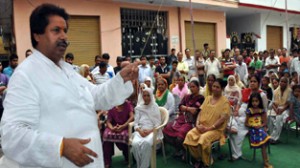 Minister for Housing Raman Bhalla addressing public gathering at Nai Basti on Sunday.