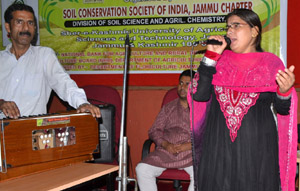 Artists presenting colourful item during symposium at SKUAST in Jammu.