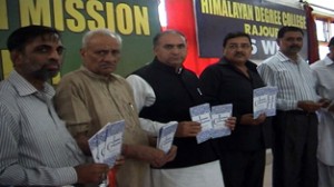 MLA Shabir Ahmad Khan and others releasing a book during a function at Rajouri on Sunday.