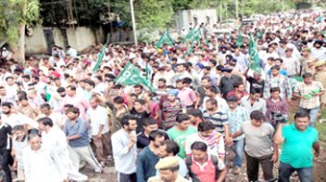 PDP activists demonstrating against power crisis at Gandhi Nagar on Thursday.