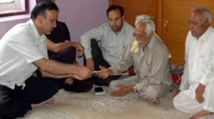 MoS Home, Sajjad Ahmed Kichloo handing over ex-gratia relief cheque to a beneficiary at Kishtwar on Saturday. 