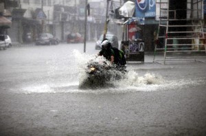 A motorcyclist passing through logged water due to heavy rainfall in Jammu on Friday morning.        —Excelsior/Rakesh