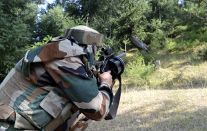 An Army jawan takes position during an encounter with militants in Tanghdar forests on Friday.     —Excelsior/Aabid Nabi