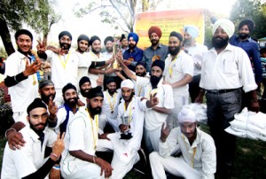 Jubilant players of Haft Chinar XI posing for a group photograph alongwith Dr Hartej Singh at Amar Singh Club in Srinagar on Wednesday.