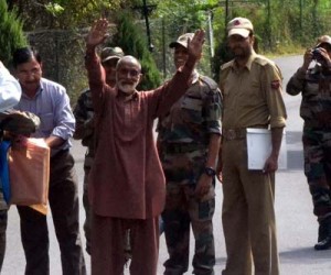 PoK citizen Mangta Khan waves towards the people before being handed over to Pakistan Rangers by the Indian officials during a flag meeting at the Kaman Post, Uri on Saturday. —Excelsior/Aabid Nabi