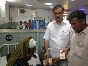 MoS Home Sajjad Kichloo handing over ex-gratia to the victims of border firing.