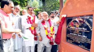 Minister for PWD, Abdul Majid Wani laying foundation stone of road projects on Monday.