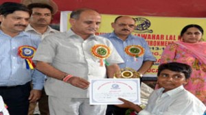 Deputy Chief Minister Tara Chand presenting certificate to a student on Wednesday.