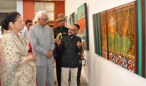 Governor NN Vohra and First Lady Usha Vohra looking at  a painting during an art exhibition at DPS on Tuesday. 