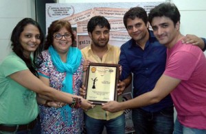 Crew members of film, “Identity Card -a life line” showcasing best film award bagged by the film at American International Film Festival.