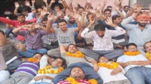 PHE daily rated, CP workers staging protest in Jammu on Tuesday. -Excelsior/Rakesh