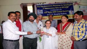 Project Director, JKSAPCS Dr Mohan Singh presenting a trophy to one of the participants during HIV/AIDS awareness seminar held at Kathua.
