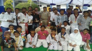 Winners and other participants of Taekwondo Championship posing for a group photograph with Sub-Inspector, Rahul Mahajan, at Jammu.
