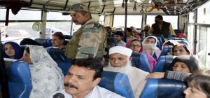 Stranded PoK people on way back home in Special Muzaffarabad bus on Friday. —Excelsior/Aabid Nabi