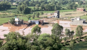 An aerial view of village Phalayan Mandal in Satwari area, which has been  cut off after the bridge connecting it was washed away in flash floods. More pictures on page Nos. 3 & 5. —Excelsior/Rakesh