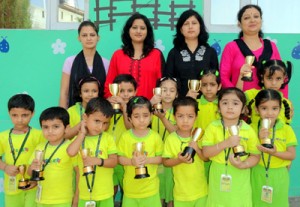 Winners of Poem recitation competition posing for a group photograph at Apple Kids School. 