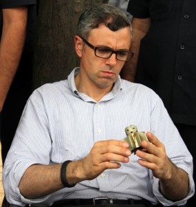 Chief Minister Omar Abdullah looks at a shell fired by Pakistan in a house during his tour of border areas on Tuesday. -Excelsior/Rakesh