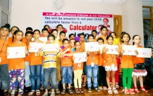 Students displaying certificates awarded by Career Abacus while posing for a group photograph. 