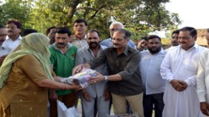 PDP leader Vikramaditya distributing relief items to flood affected victim at Jammu on Sunday. 