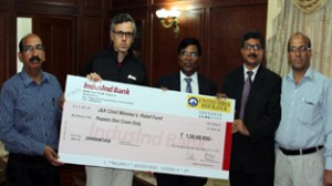 Officers of the United India Insurance Company presenting cheque of Rs 1 crore to Chief Minister, Omar Abdullah at Srinagar on Tuesday.