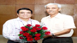 IT Commissioner J&K A K Thatai presenting bouquet to outgoing JCIT R K Kakar at Jammu on Tuesday.