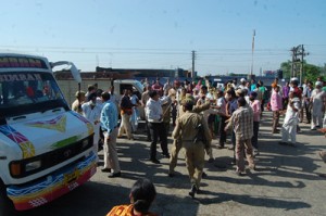 Police in civil clothes chasing protestors at Vijaypur on Sunday.     -Excelsior/ Gautam