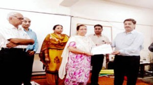 Certificate of participation being given to a teacher during valedictory function of 6-day workshop on Saturday.