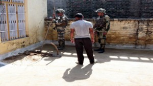 BSF Bomb Disposal Squad members defusing mortar shell in a house in Arnia town on Sunday. More pics on page 5. -Excelsior/Rakesh