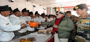 Prime Minister Narendra Modi sharing sweets with Army jawans on the occasion of Diwali, at Siachen base camp. Chief of Army Staff, General Dalbir Singh is also seen in the picture. (UNI)