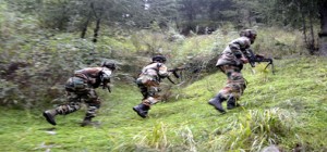 Army jawans in action at the site of encounter in Waderbala forest area of Rajwara in Handwara area on Tuesday. -Excelsior/Aabid Nabi