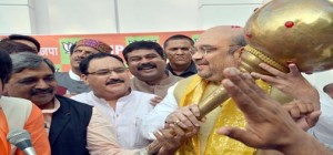 BJP president Amit Shah being presented a mace by the party workers during a celebration on party's landslide victory in Maharashtra and Haryana Assembly polls at party headquarters in New Delhi on Sunday.(UNI)