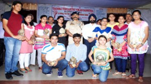 Recipients of Tagore Gourav Awards posing with dignitaries at GDC Kathua on Sunday.