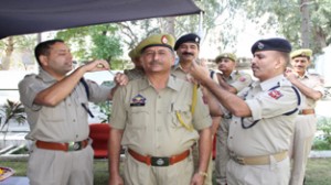 Senior Railway police officers installing badges to a newly promoted ASI at Jammu on Wednesday.