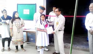 Dignitaries felicitating student while launching computer course to provide computer awareness among students.