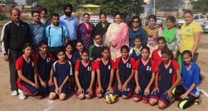 Volleyball players posing along with the chief guest and other dignitaries during an open tourney in Jammu.