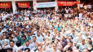 PHE workers staging protest dharna at Chief Engineer’s Office in Jammu on Monday.—Excelsior/Rakesh