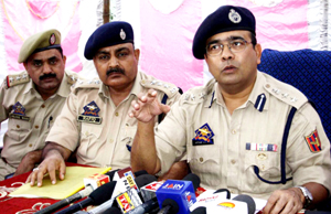 SSP Jammu Uttam Chand interacting with media persons at Jammu. SDPO East Mohammad Rafiq and SHO Channi Inspector Aejaz Wani also seen in the picture. -Excelsior/Rakesh