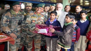 Army’s 15 Corps Commander, Lt. Gen Subrata Saha interacting with orphans in an orphanage in Sopore on Thursday. -Excelsior/Aabid Nabi