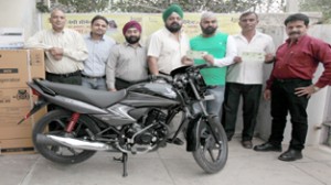 GPS Walia presenting Honda motorcycle to winner of Jaypee Cement Scratch Coupon Scheme at Jammu on Tuesday. —Excelsior/Rakesh